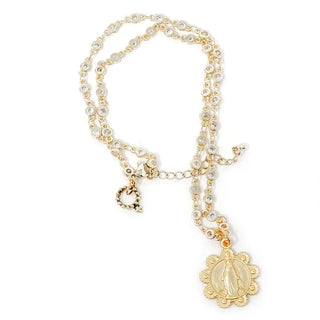 Gold necklace with a decorative pendant on a white background