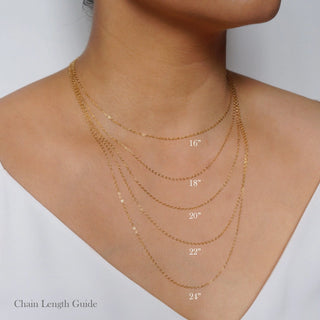 Gold chain necklace with labeled lengths on a person's neck against a white background