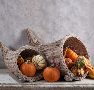 Whitewashed woven cornucopia baskets styled with pumpkins and decorative gourds