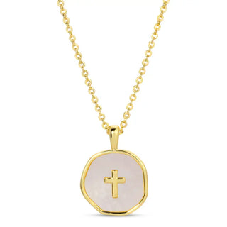 Gold necklace with a round pendant featuring a cross on a white background