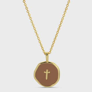 Gold necklace with a round pendant featuring a cross on a white background