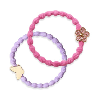 Two hair elastic bands, one pink and one purple, with butterfly-shaped charms on a white background.