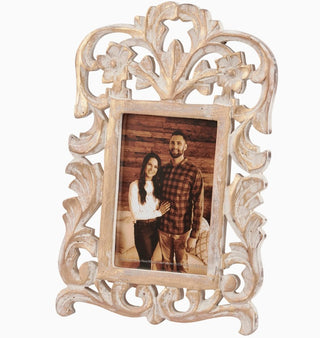Ornate 4x6 picture frame with distressed antique gold finish, intricate floral filigree scrollwork, and a sample couple's photograph displayed against a white background.