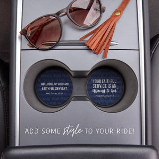 Navy Faithful Service Scripture coasters displayed inside vehicle cup holders beside sunglasses and a leather tassel.