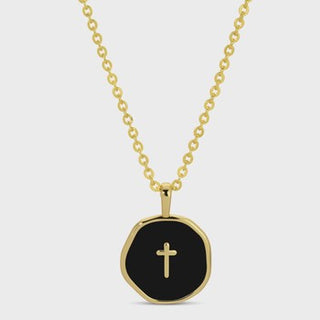 Gold necklace with a black pendant featuring a cross on a white background