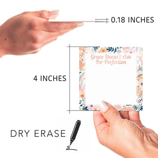 Hands holding the 4-inch floral dry erase tile with its approximate 0.18-inch thickness shown.